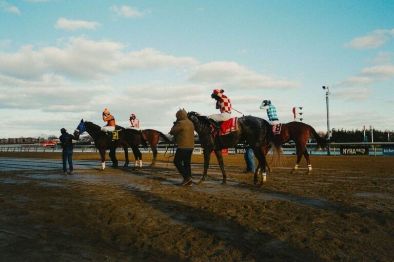 Horses and riders on the Aqueduct Racetrack surface during NYRA's farewell weekend coverage. Credit: Henry Kornaros / NYRA.